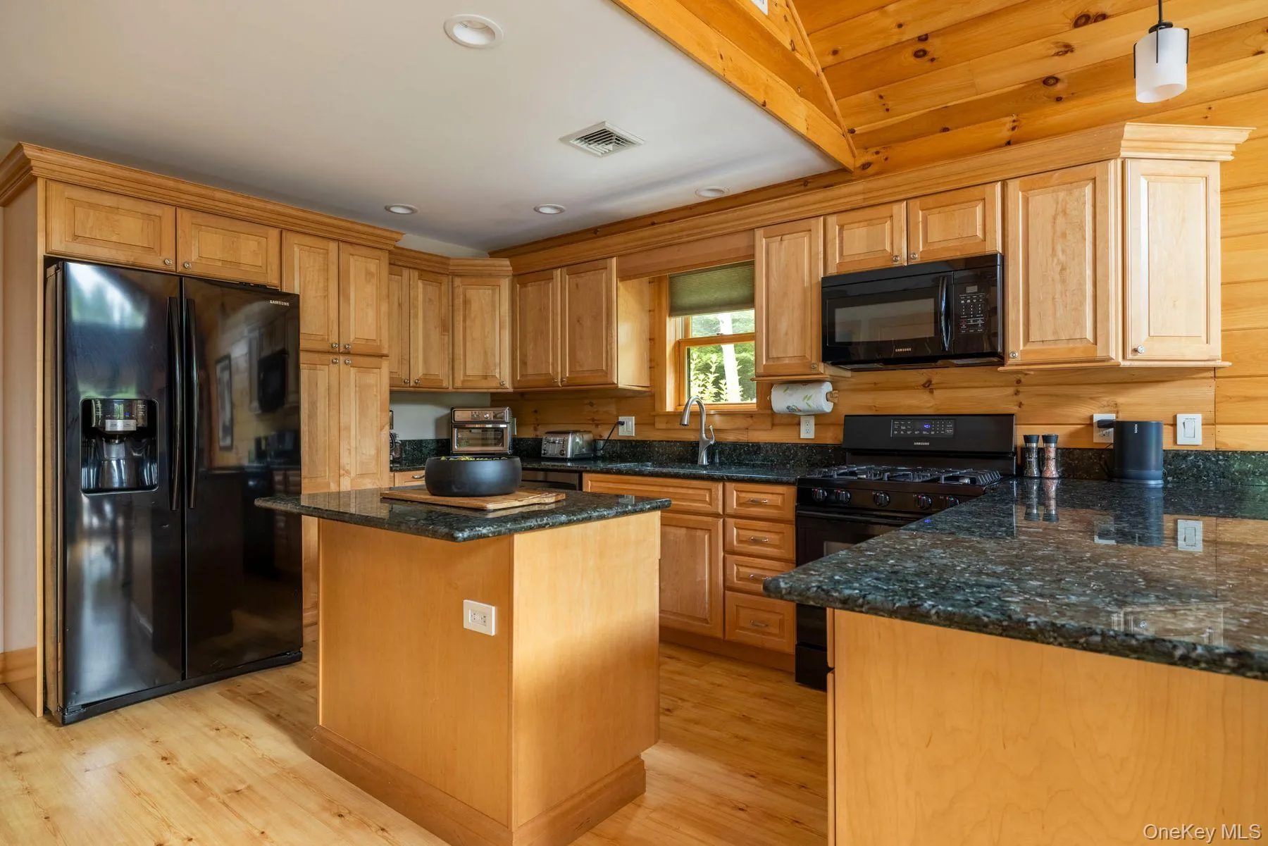 Warm wood cabinetry and granite countertops Warm wood cabinetry and granite countertops