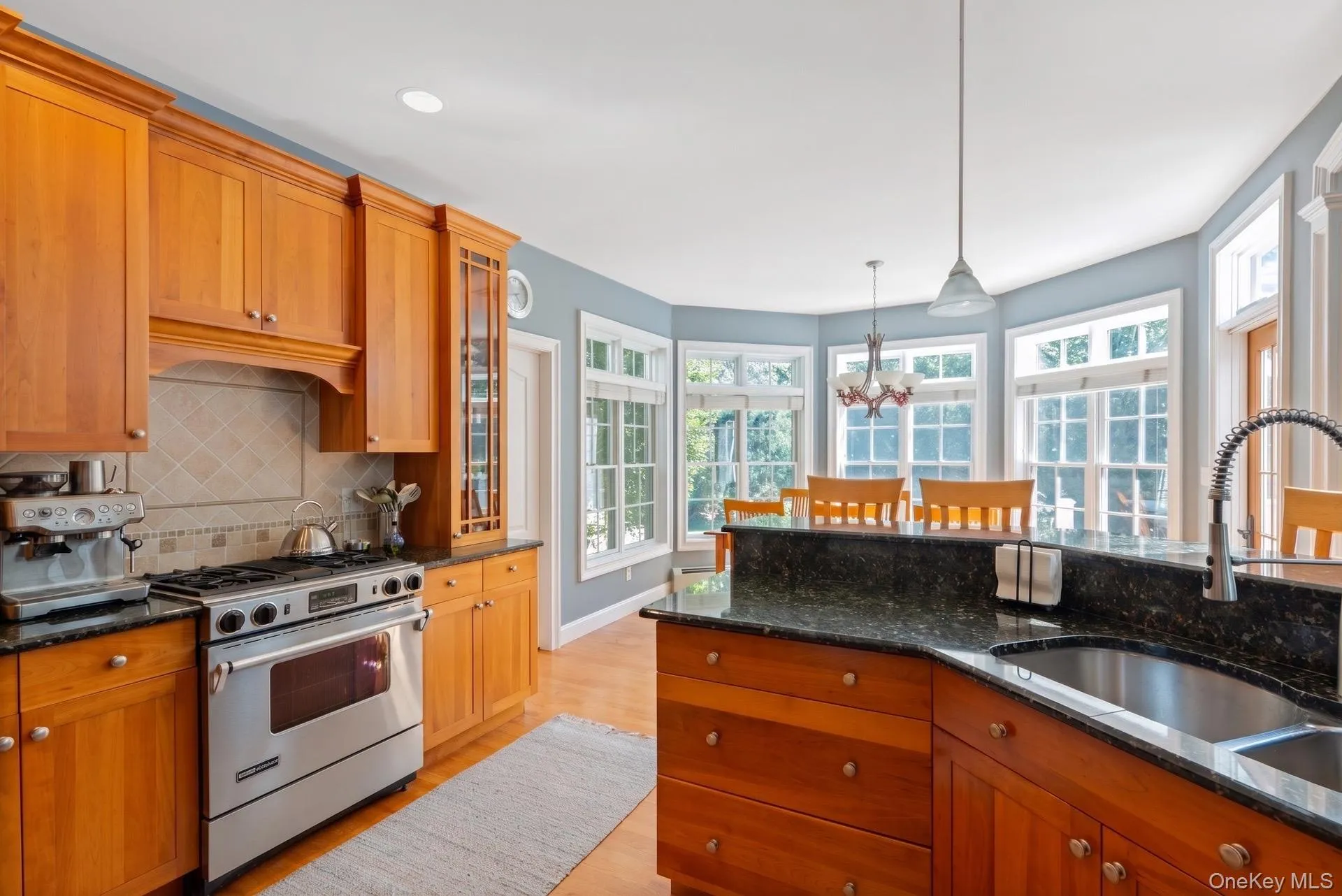 Open kitchen with granite countertops and stainless-steel appliances Open kitchen with granite countertops and stainless-steel appliances