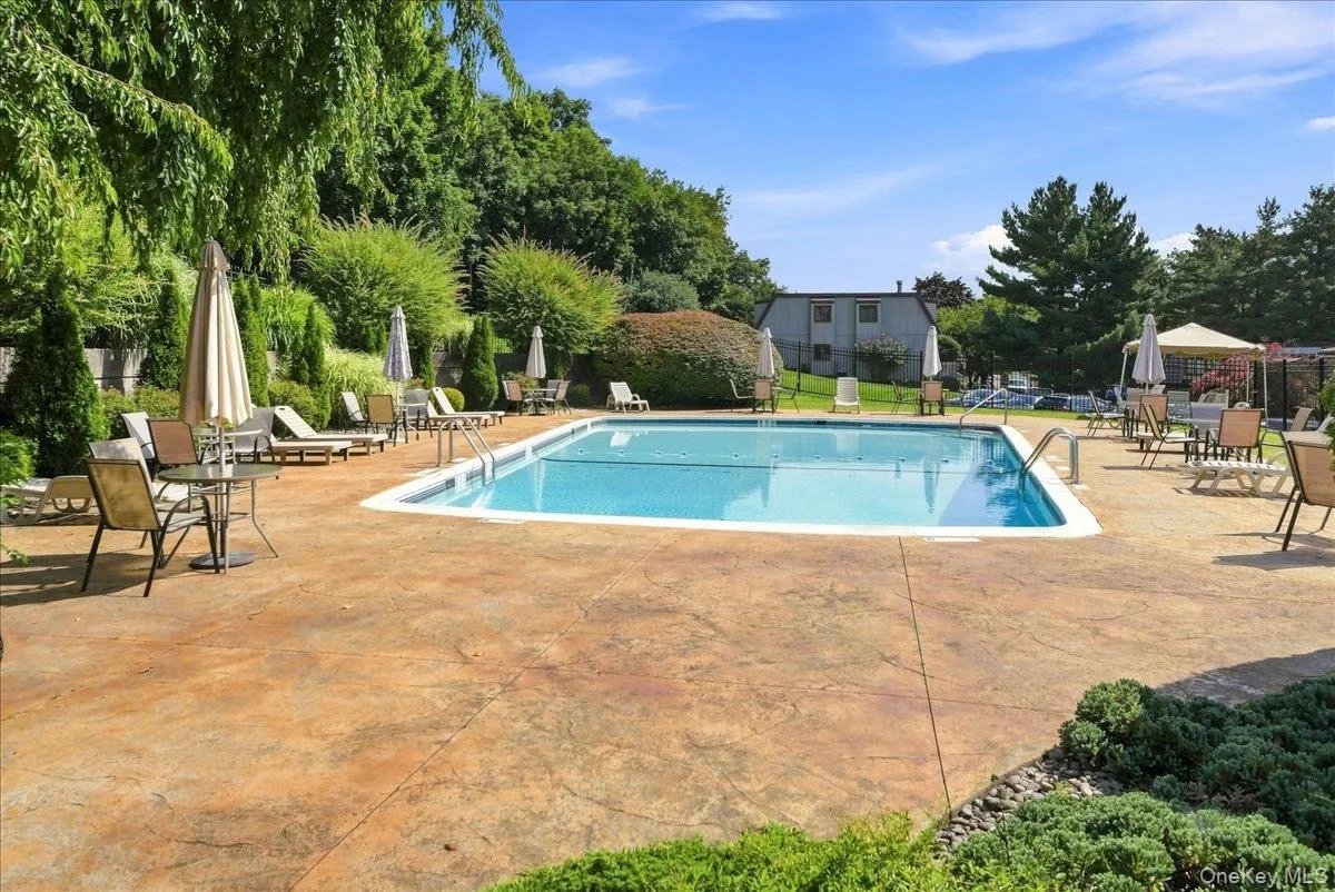 Rectangular swimming pool with integrated steps, surrounded by an expansive stamped concrete patio Rectangular swimming pool with integrated steps, surrounded by an expansive stamped concrete patio