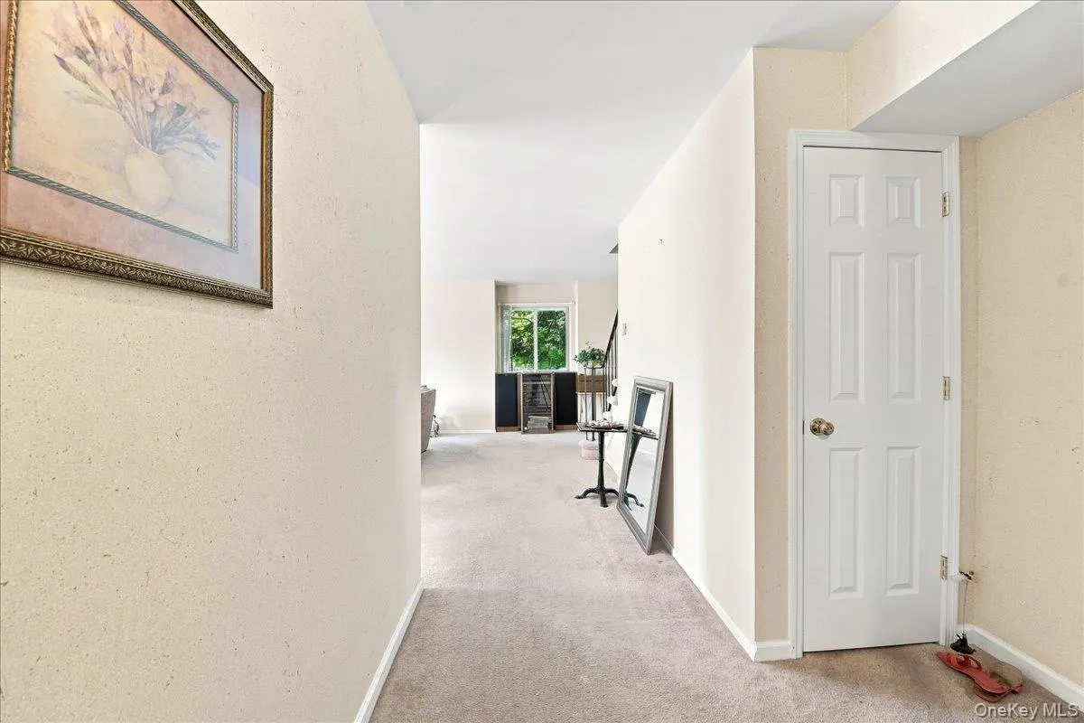 Entryway with paneled interior door and neutral-toned carpeting Entryway with paneled interior door and neutral-toned carpeting