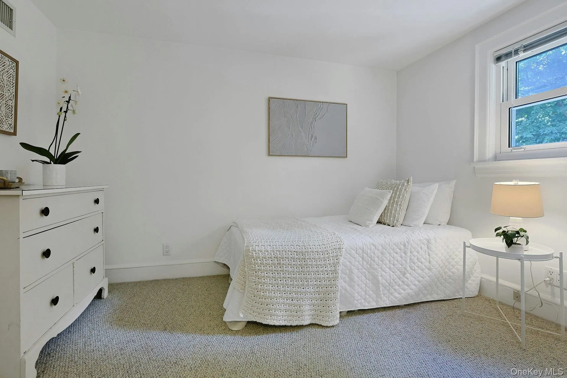 A bright and inviting third-floor bedroom offers generous space and a peaceful setting, ideal for family or guests. A bright and inviting third-floor bedroom offers generous space and a peaceful setting, ideal for family or guests.
