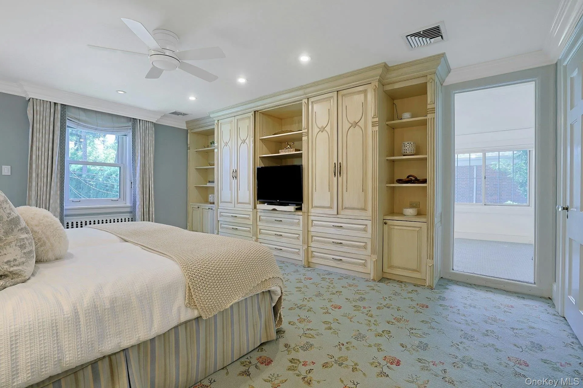 A wall of handsome built-in cabinetry provides exceptional storage, while a door leads directly to the adjoining private study. A wall of handsome built-in cabinetry provides exceptional storage, while a door leads directly to the adjoining private study.