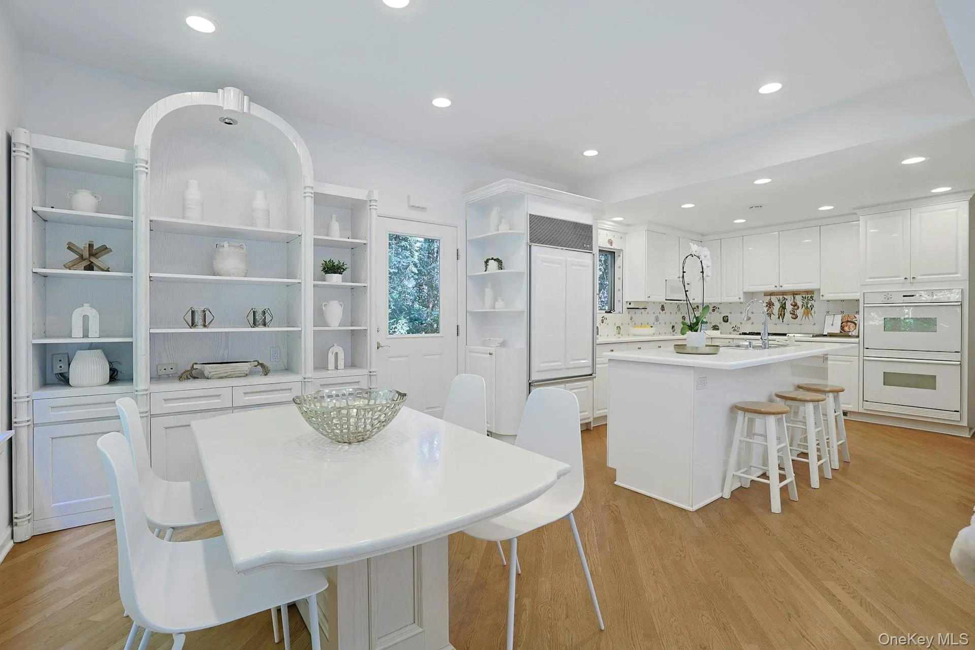 A generous breakfast area with custom built-in cabinetry offers a relaxed setting for everyday dining just steps from the kitchen. A generous breakfast area with custom built-in cabinetry offers a relaxed setting for everyday dining just steps from the kitchen.