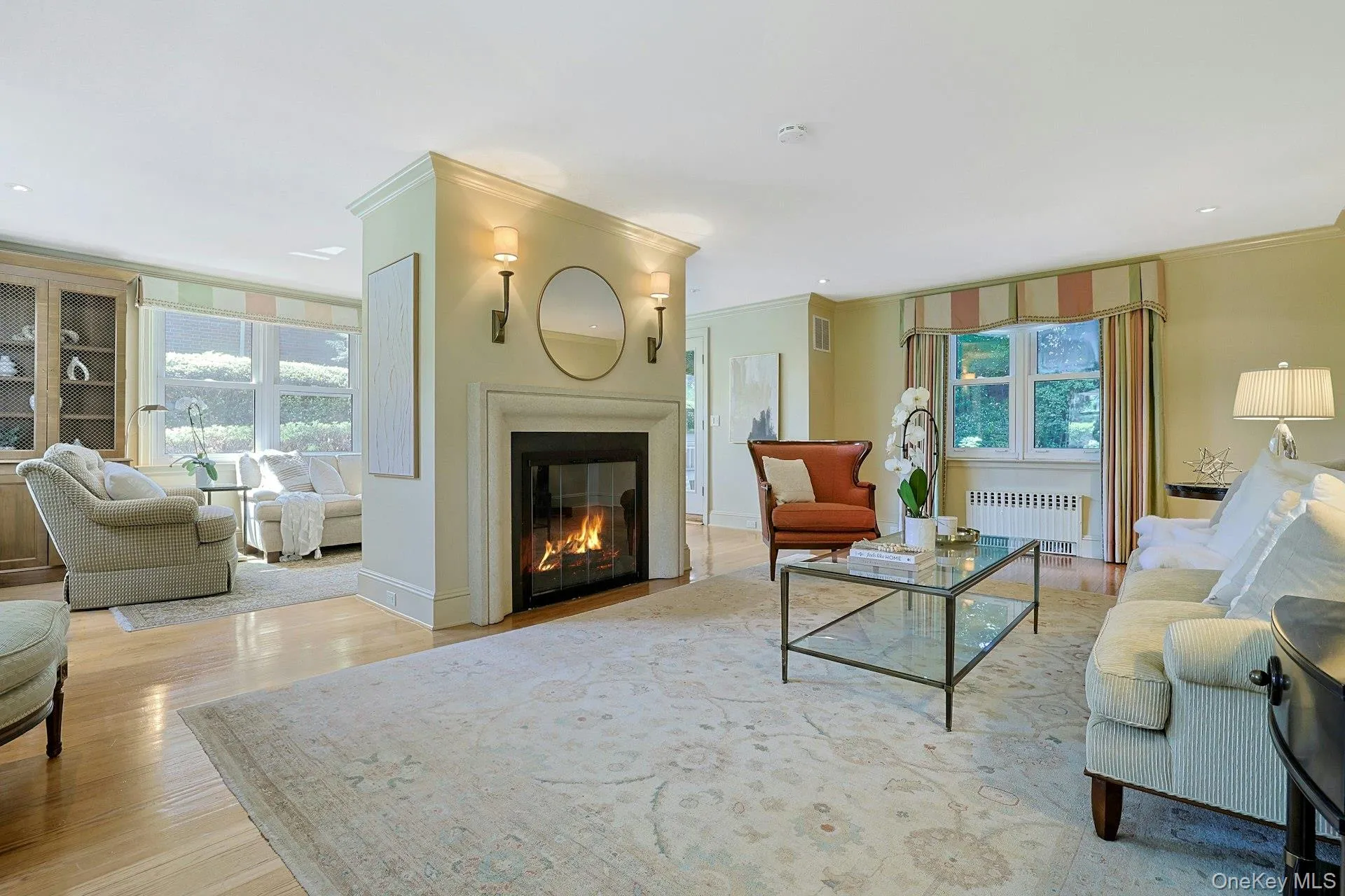 Another view of the living room highlights its classic gas fireplace, hardwood floors and inviting connection to the adjoining sunroom. Another view of the living room highlights its classic gas fireplace, hardwood floors and inviting connection to the adjoining sunroom.