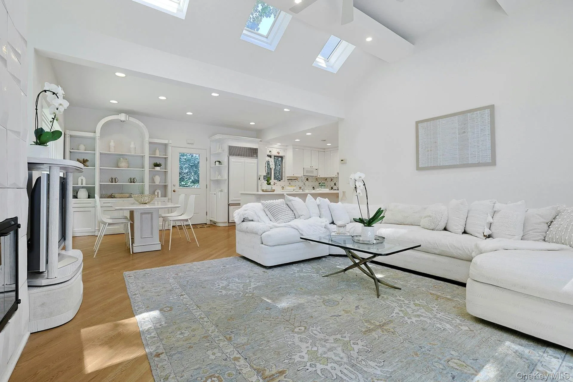 Soaring cathedral ceilings and multiple skylights fill this impressive family room with natural light, while the gas fireplace adds warmth and ambiance. Soaring cathedral ceilings and multiple skylights fill this impressive family room with natural light, while the gas fireplace adds warmth and ambiance.
