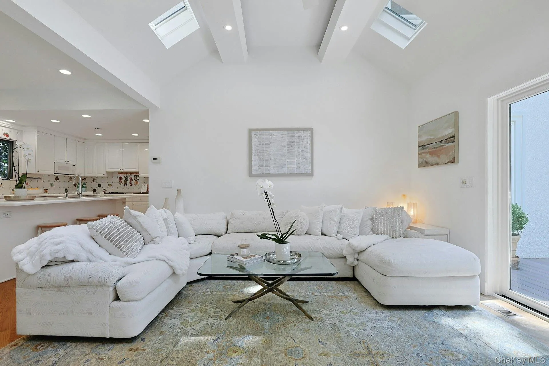 Skylights illuminate the soaring ceiling while the open connection to the kitchen makes this an ideal hub for family and friends. Skylights illuminate the soaring ceiling while the open connection to the kitchen makes this an ideal hub for family and friends.