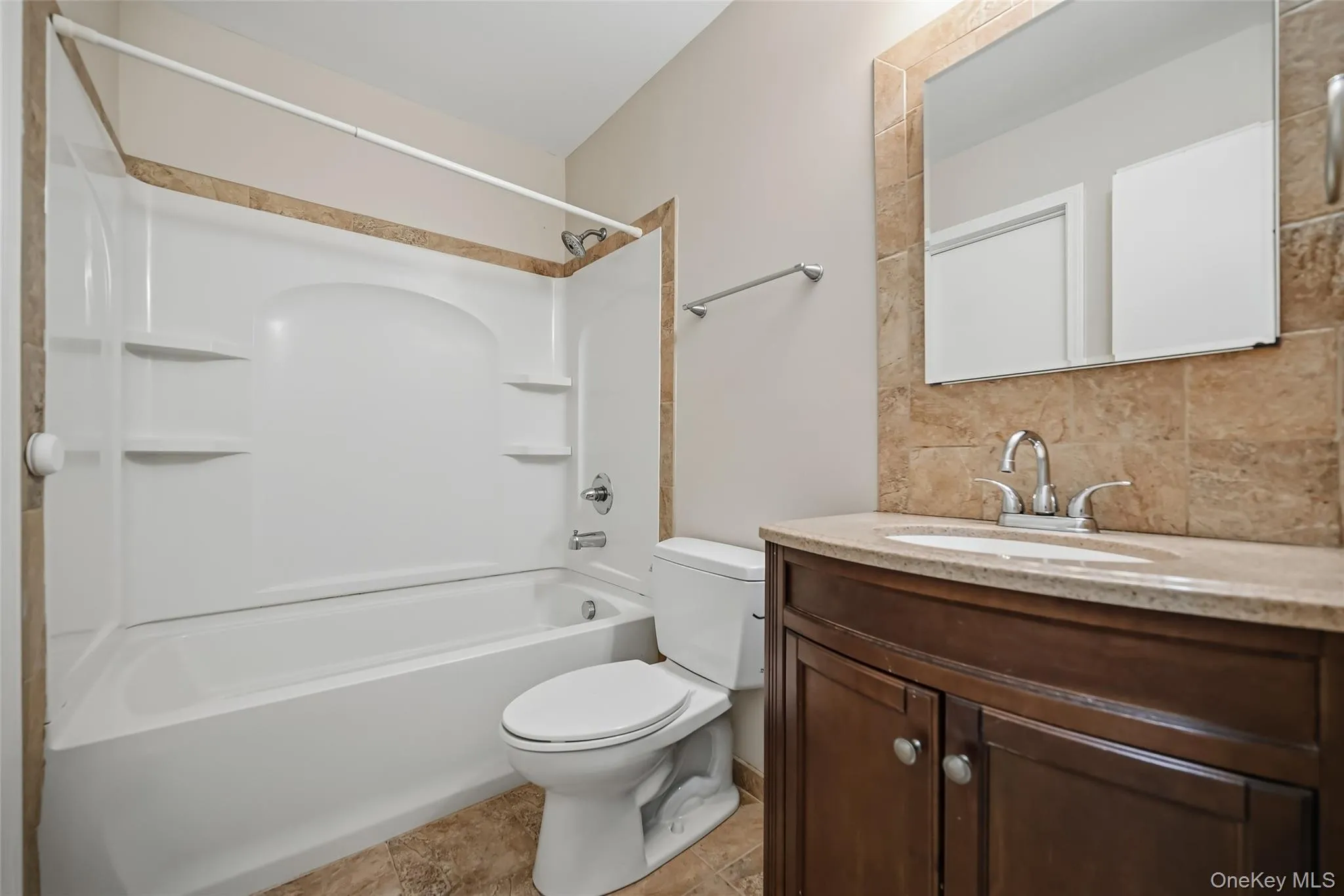 Dark wood-finish vanity with a stone-finish countertop, undermount sink, and chrome fixtures Dark wood-finish vanity with a stone-finish countertop, undermount sink, and chrome fixtures