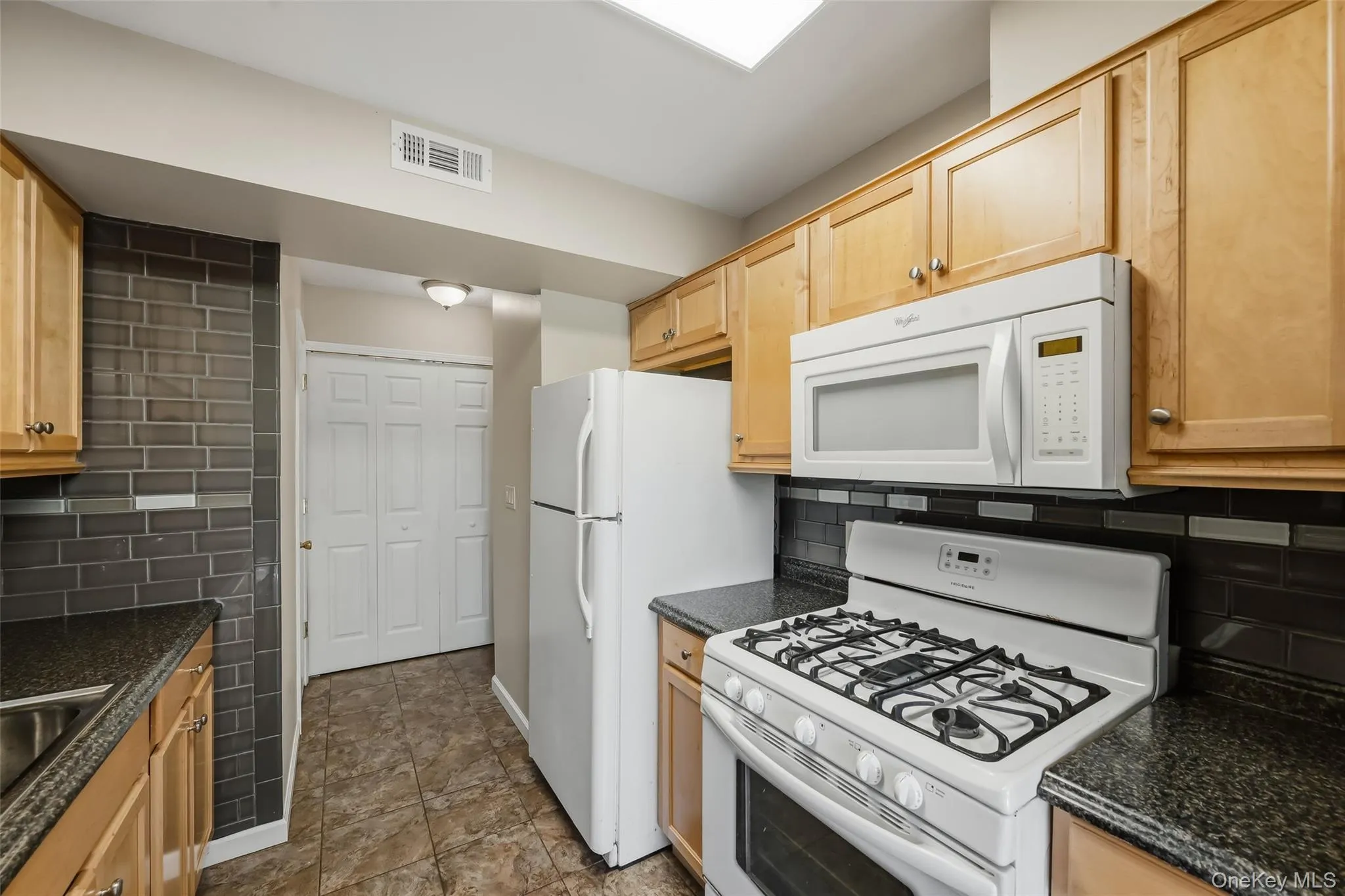 Kitchen featuring wood-finish cabinetry Kitchen featuring wood-finish cabinetry