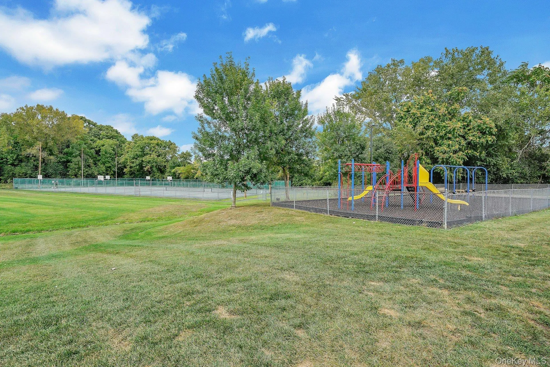 Community playground, tennis court, and basketball court Community playground, tennis court, and basketball court