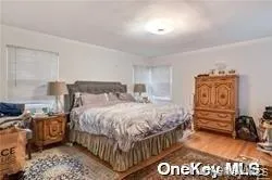 Primary Suite with door to backyard. Hardwood flooring throughout Primary Suite with door to backyard. Hardwood flooring throughout
