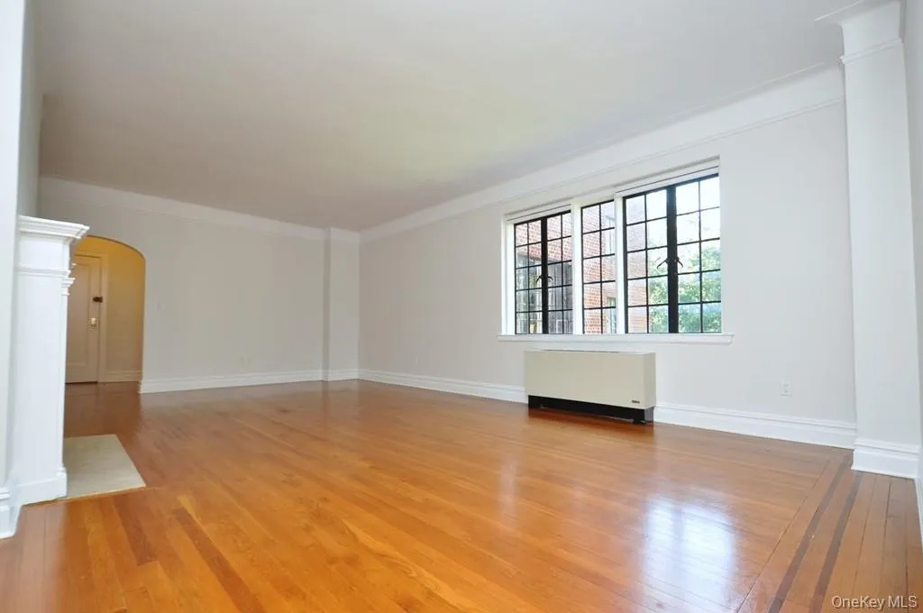 Large Living Room, casement windows, hardwood floors and arched doorways. The living Room is 23'-11" x 14'-9". Large Living Room, casement windows, hardwood floors and arched doorways. The living Room is 23'-11" x 14'-9".