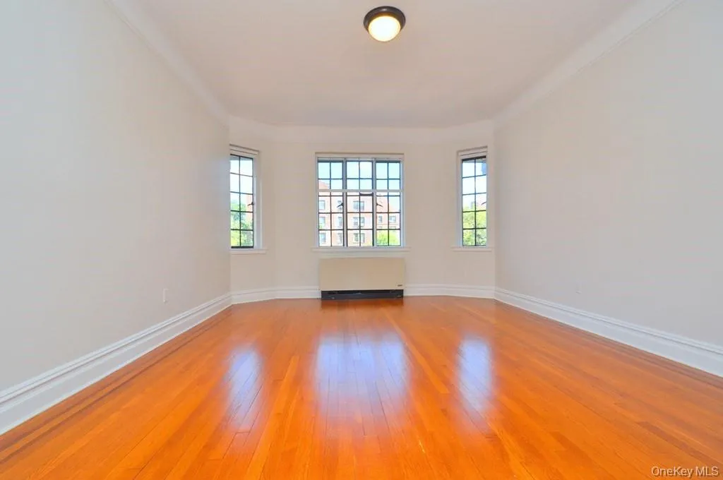 Large formal dining room with hardwood floors, arched doorways and casement windows. The dining room is 15'-11" x 13'-2". Large formal dining room with hardwood floors, arched doorways and casement windows. The dining room is 15'-11" x 13'-2".