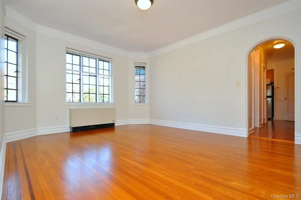 Large formal dining room with hardwood floors, arched doorways and casement windows. The dining room is 15'-11" x 13'-2". Large formal dining room with hardwood floors, arched doorways and casement windows. The dining room is 15'-11" x 13'-2".