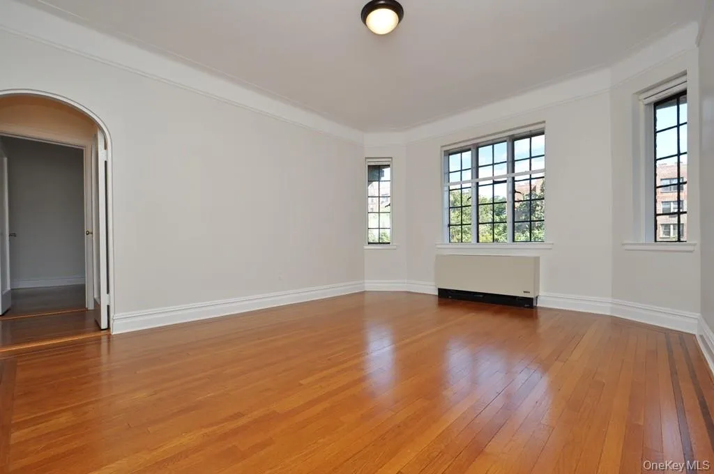 Large formal dining room with hardwood floors, arched doorways and casement windows. The dining room is 15'-11" x 13'-2". Large formal dining room with hardwood floors, arched doorways and casement windows. The dining room is 15'-11" x 13'-2".