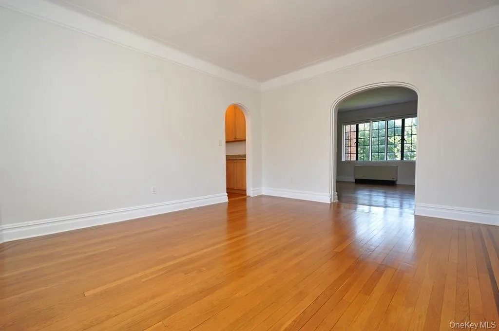 Large formal dining room with hardwood floors, arched doorways and casement windows. The dining room is 15'-11" x 13'-2". Large formal dining room with hardwood floors, arched doorways and casement windows. The dining room is 15'-11" x 13'-2".