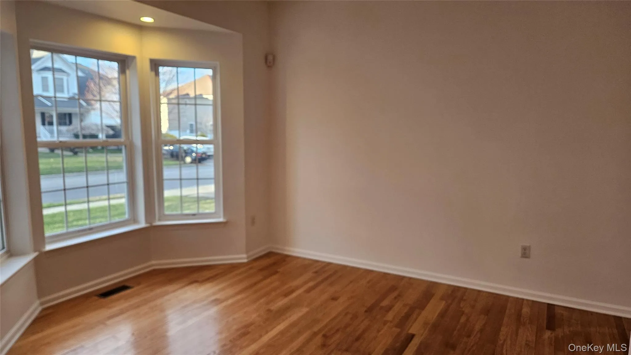 Formal living room with baseboards, recessed lighting, and wood finished floors Formal living room with baseboards, recessed lighting, and wood finished floors