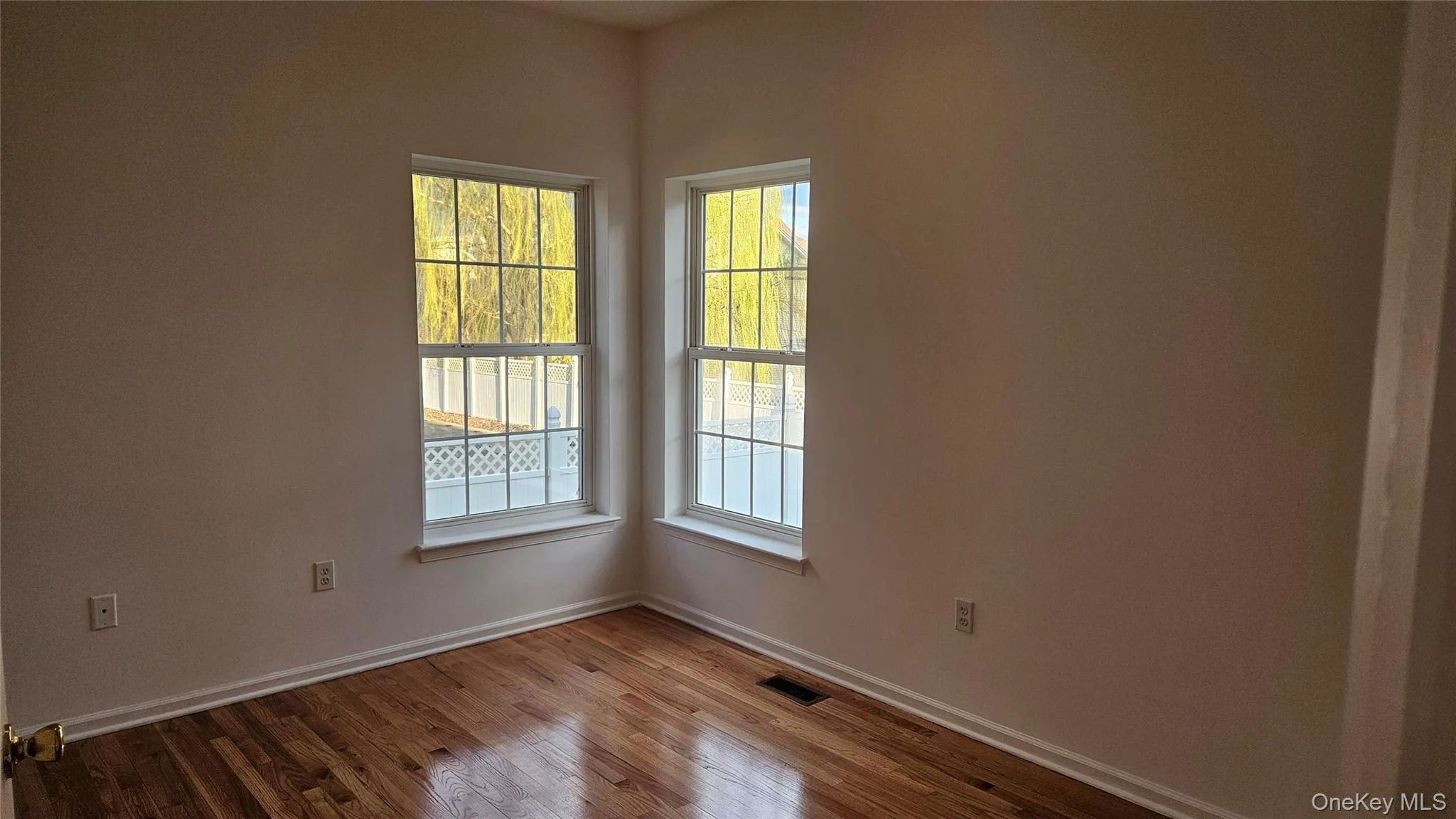 1st floor office featuring visible vents, baseboards, and wood finished floors 1st floor office featuring visible vents, baseboards, and wood finished floors