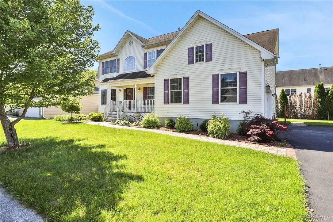 View of front of house with covered porch and a front lawn View of front of house with covered porch and a front lawn