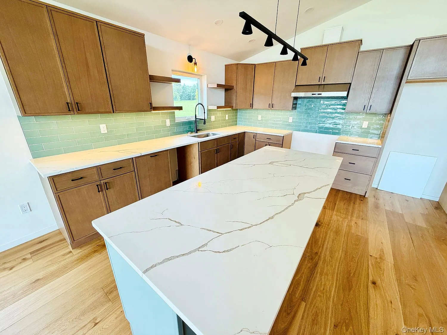 Gorgeous quartz countertops; large island. Gleaming wood floors. Gorgeous quartz countertops; large island. Gleaming wood floors.