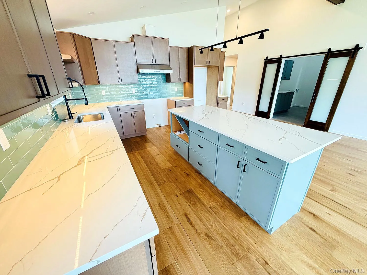 Beautiful quartz counters, lots of cabinet space; island Beautiful quartz counters, lots of cabinet space; island