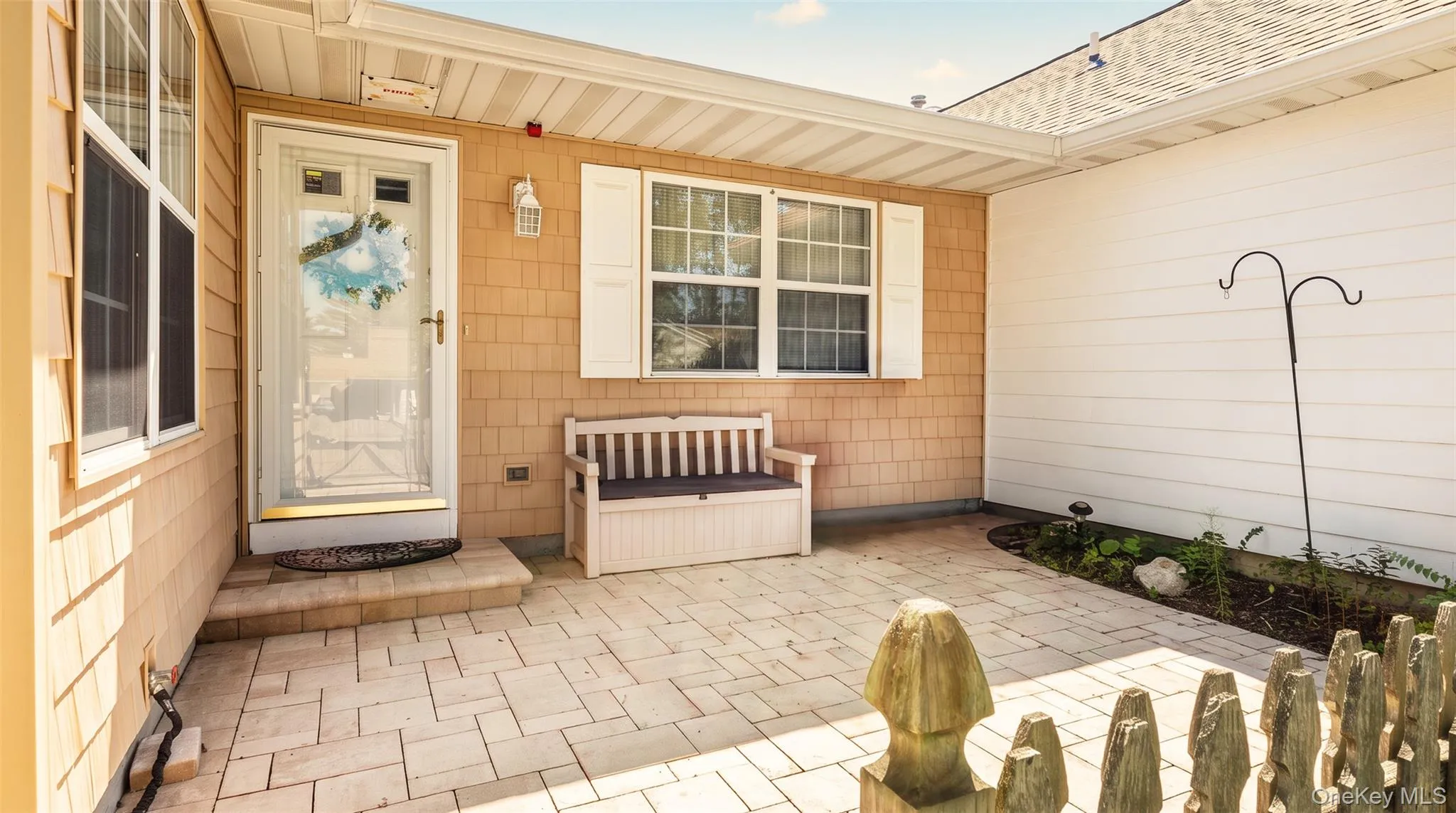 Covered entry with stone paver patio Covered entry with stone paver patio