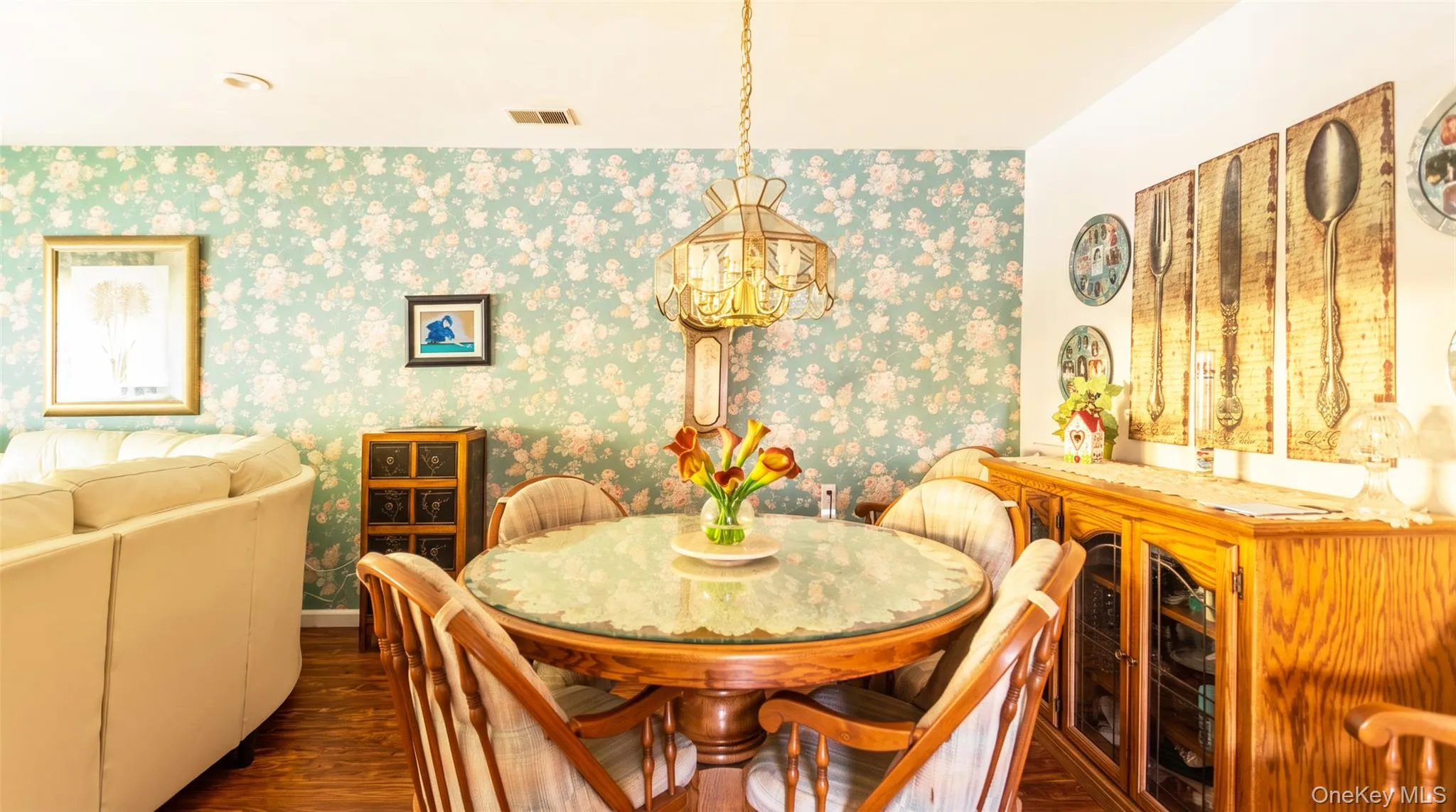 Dining area featuring a pendant light fixture and wood-finish flooring Dining area featuring a pendant light fixture and wood-finish flooring