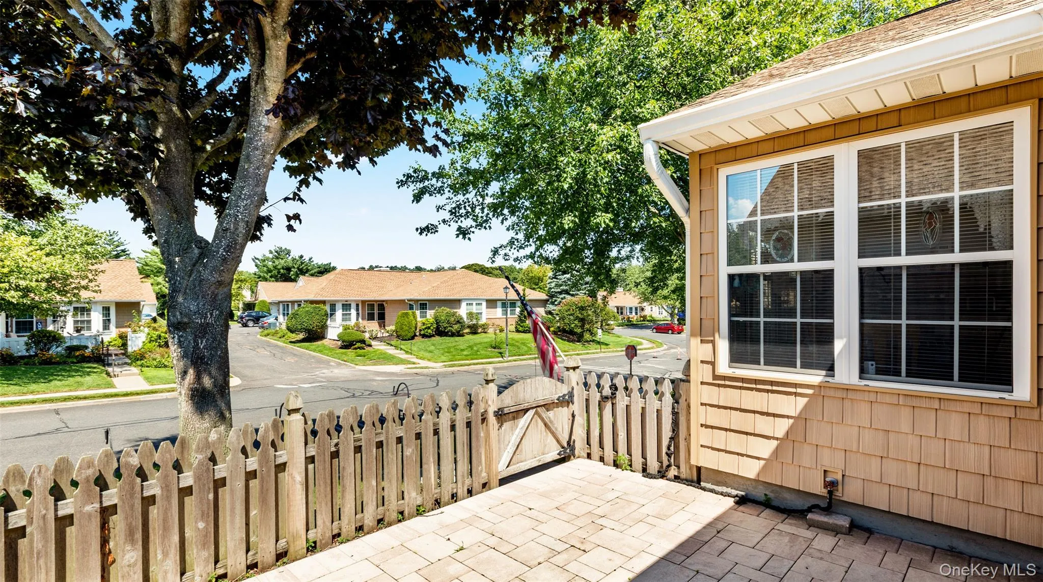 Cedar shake siding exterior with white window trim and a white gutter system Cedar shake siding exterior with white window trim and a white gutter system