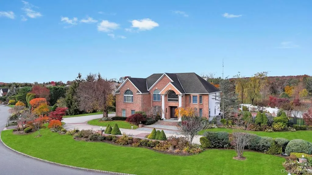 View of front of property featuring a front yard, brick siding, and driveway View of front of property featuring a front yard, brick siding, and driveway
