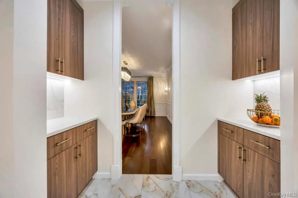 Hallway with light marble finish floors and baseboards Hallway with light marble finish floors and baseboards