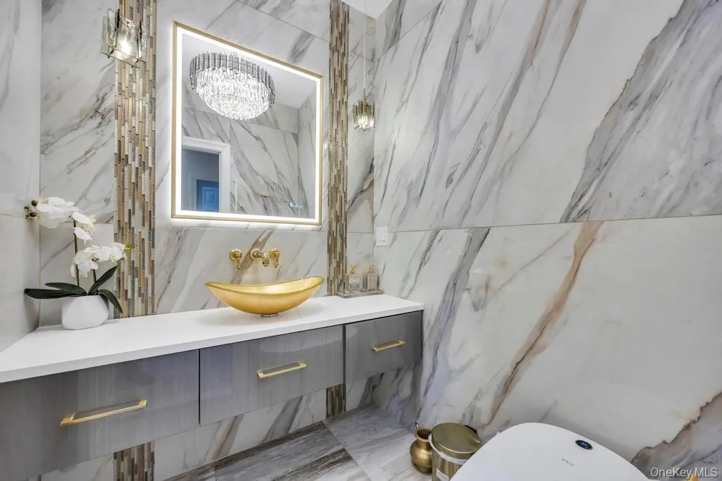 Bathroom featuring vanity and tile walls Bathroom featuring vanity and tile walls