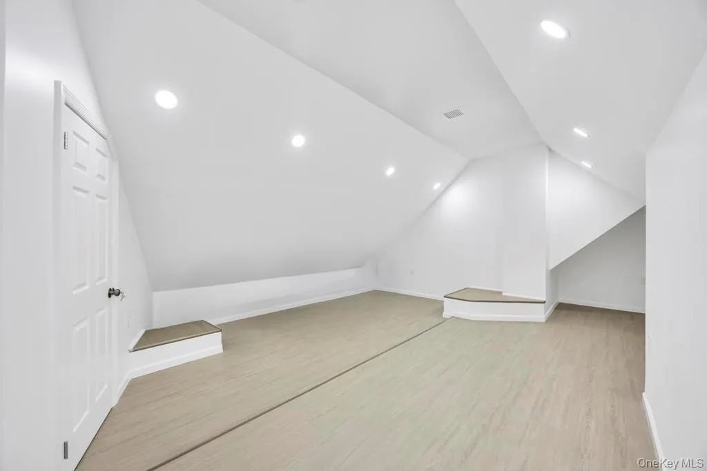 Bonus room featuring recessed lighting, light wood finished floors, and lofted ceiling Bonus room featuring recessed lighting, light wood finished floors, and lofted ceiling