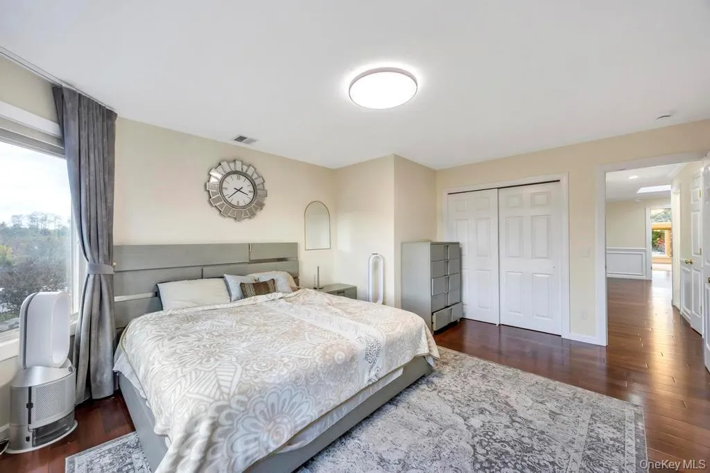 Bedroom with dark wood-style floors and a closet Bedroom with dark wood-style floors and a closet