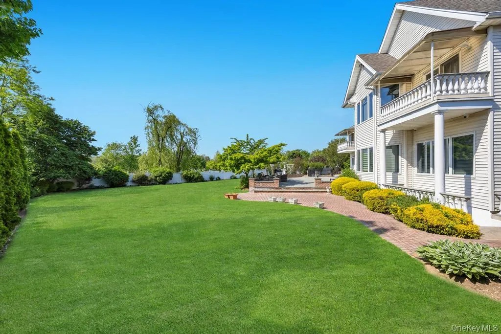 Expansive green lawn with mature perimeter landscaping Expansive green lawn with mature perimeter landscaping
