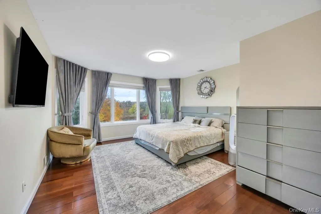Bedroom featuring dark wood-style flooring Bedroom featuring dark wood-style flooring