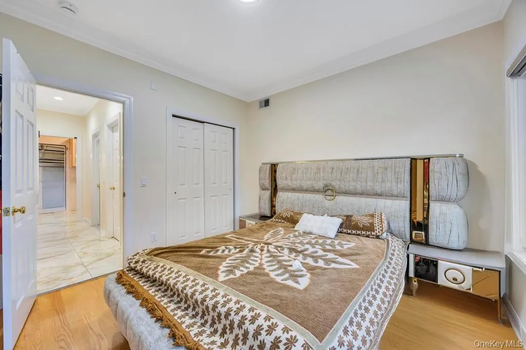 Bedroom featuring crown molding, a closet, light wood-style flooring, and recessed lighting Bedroom featuring crown molding, a closet, light wood-style flooring, and recessed lighting