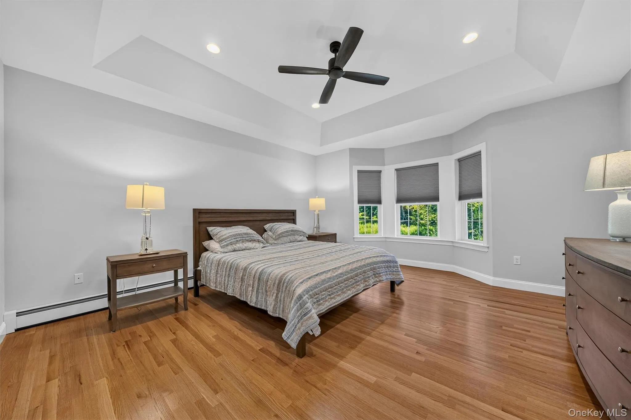 Hardwood flooring, tray ceiling, recessed lighting, ceiling fan, and bay windows Hardwood flooring, tray ceiling, recessed lighting, ceiling fan, and bay windows