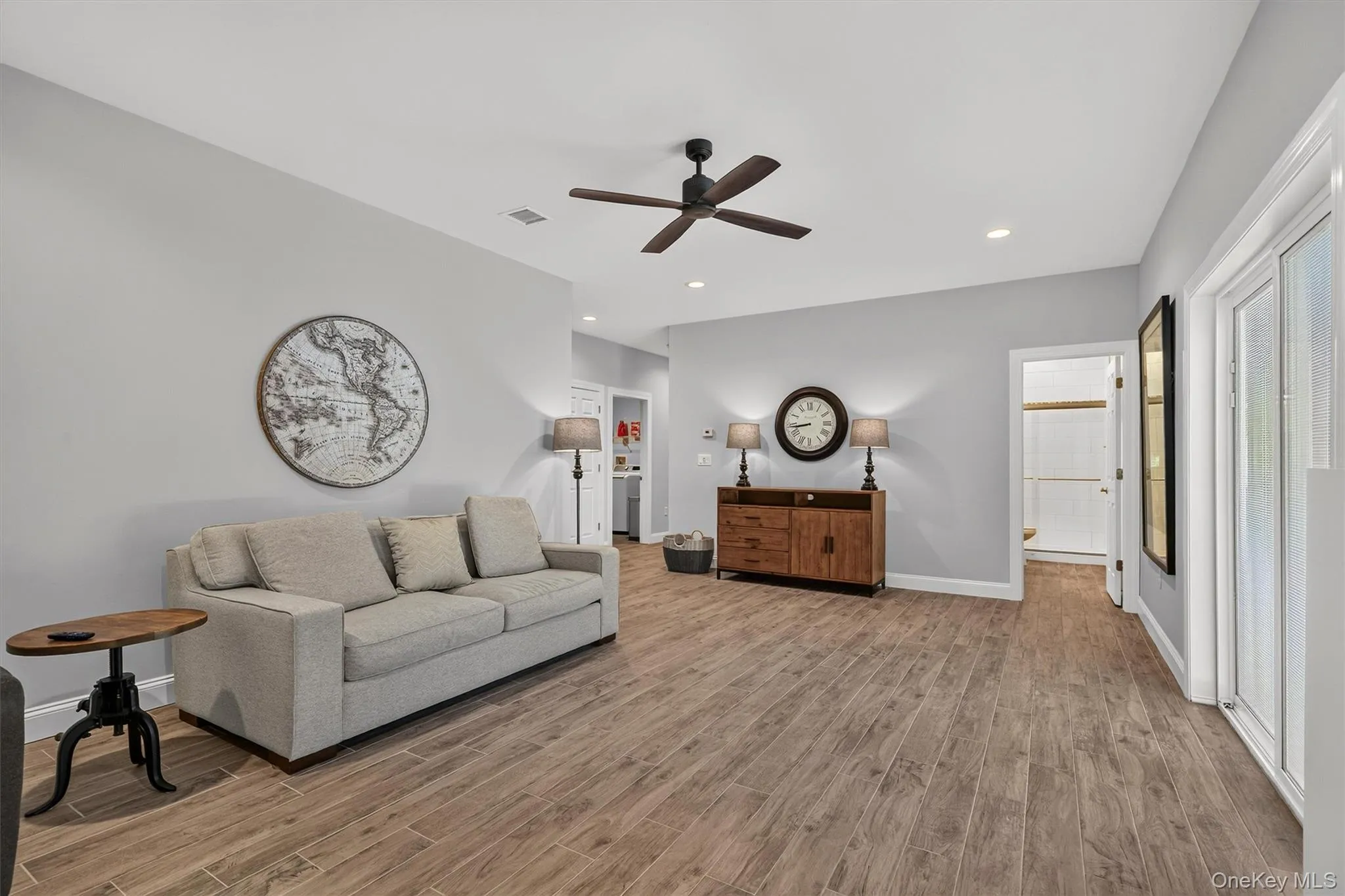 Vaulted ceiling with recessed lighting, wood-finish flooring, ceiling fan, and French doors Vaulted ceiling with recessed lighting, wood-finish flooring, ceiling fan, and French doors