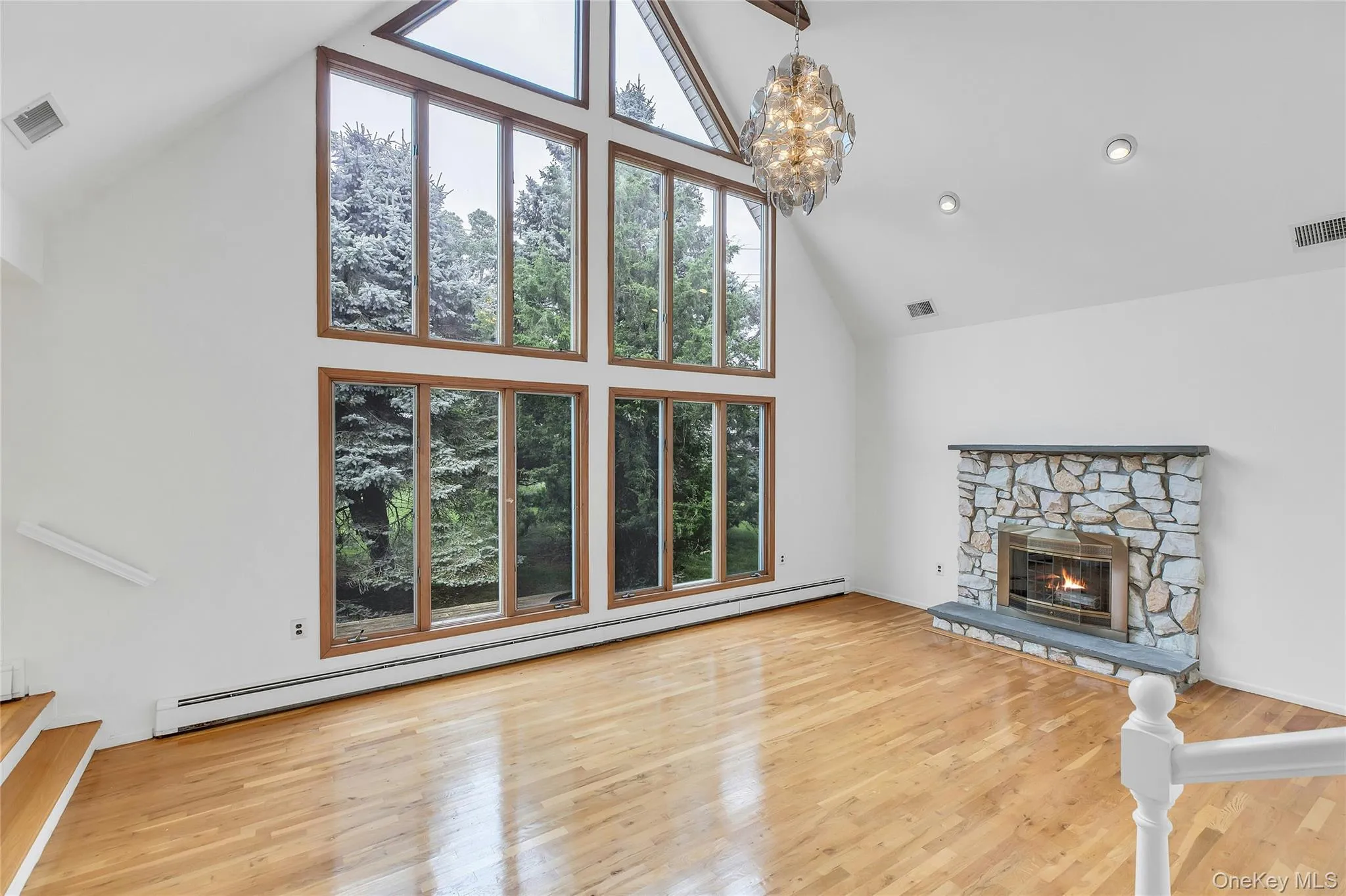 Extremely high vaulted ceilings with beams and a wall of windows for natural light Extremely high vaulted ceilings with beams and a wall of windows for natural light