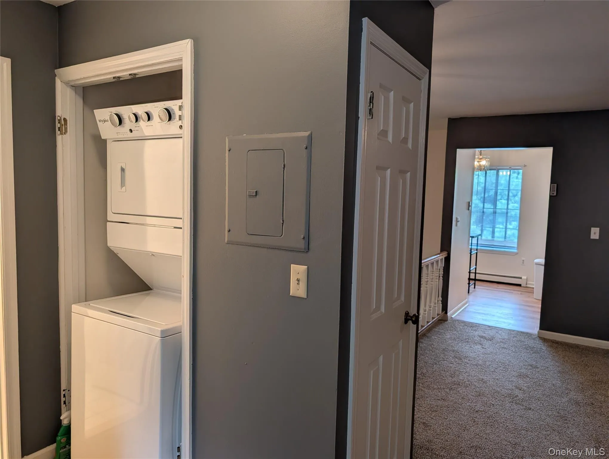 storage closet in open concept dining area/LR, view into EIK, washer/dryer next to bathroom and located conveniently across from bedroom storage closet in open concept dining area/LR, view into EIK, washer/dryer next to bathroom and located conveniently across from bedroom