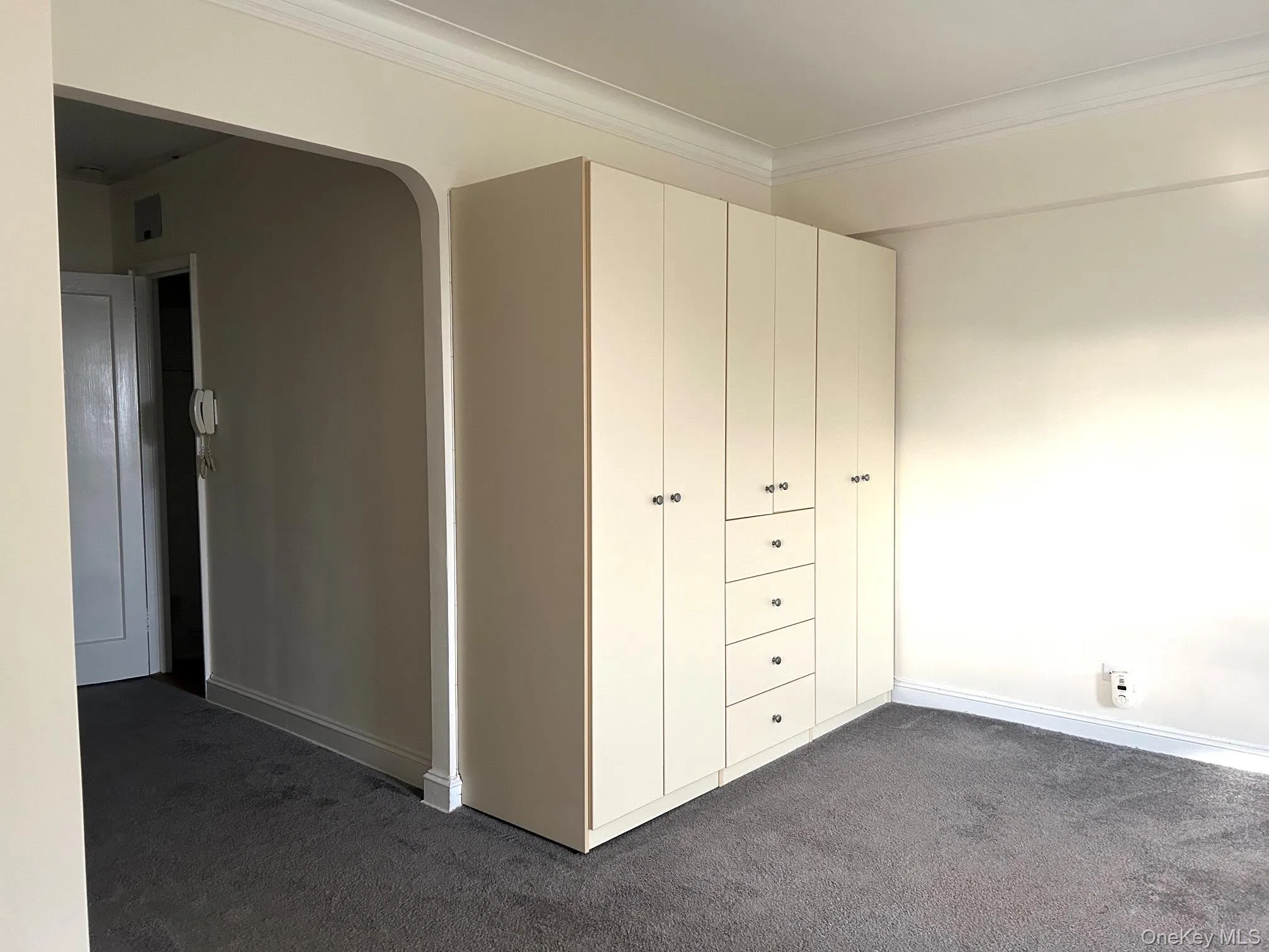 Wall Unit / Storage. Arched Entrance / Exit from Foyer with Coat Closet. Wall Unit / Storage. Arched Entrance / Exit from Foyer with Coat Closet.