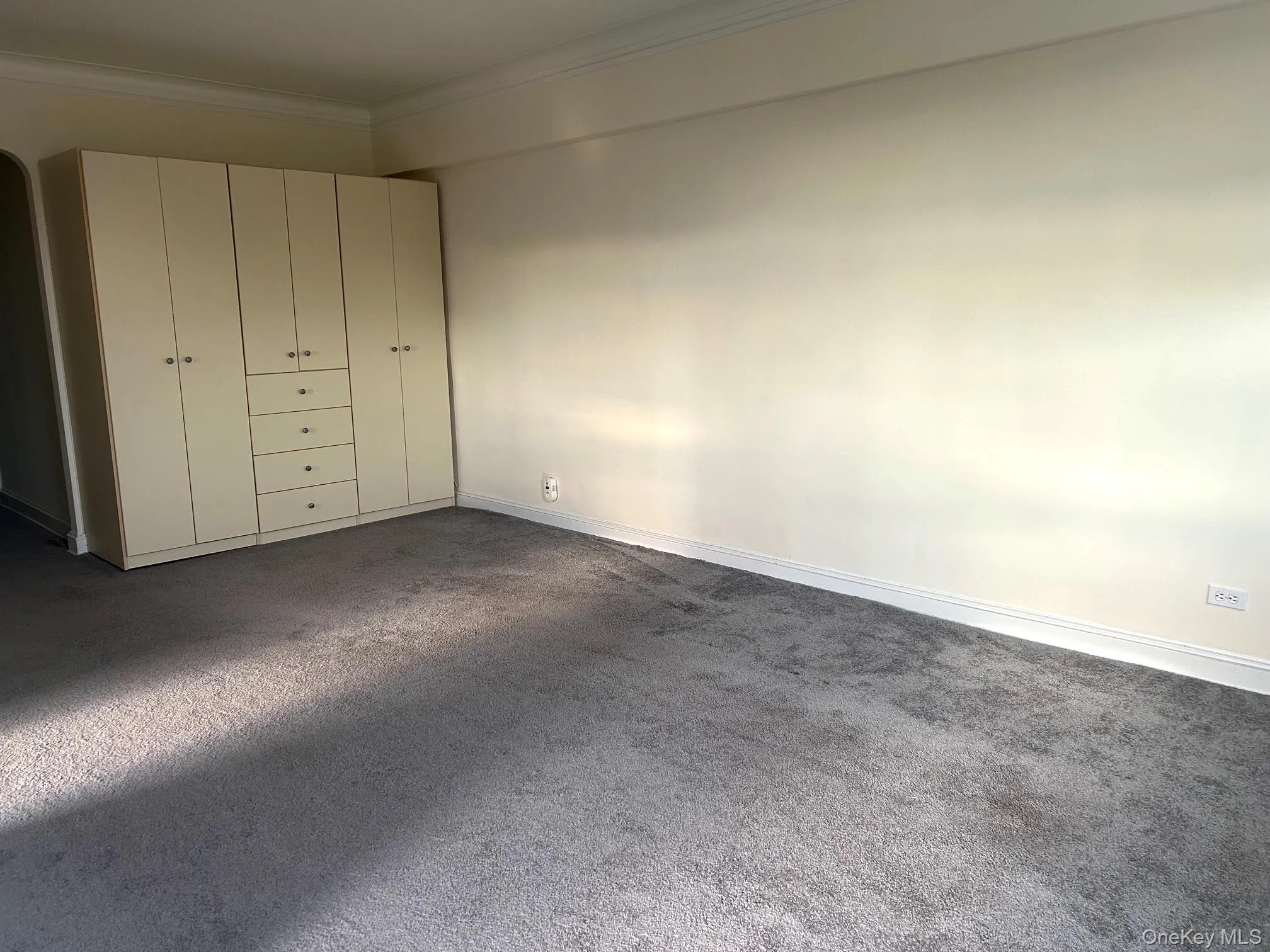 Wall unit of storage tucked away at back of living room. No need for Dressers. Wall unit of storage tucked away at back of living room. No need for Dressers.