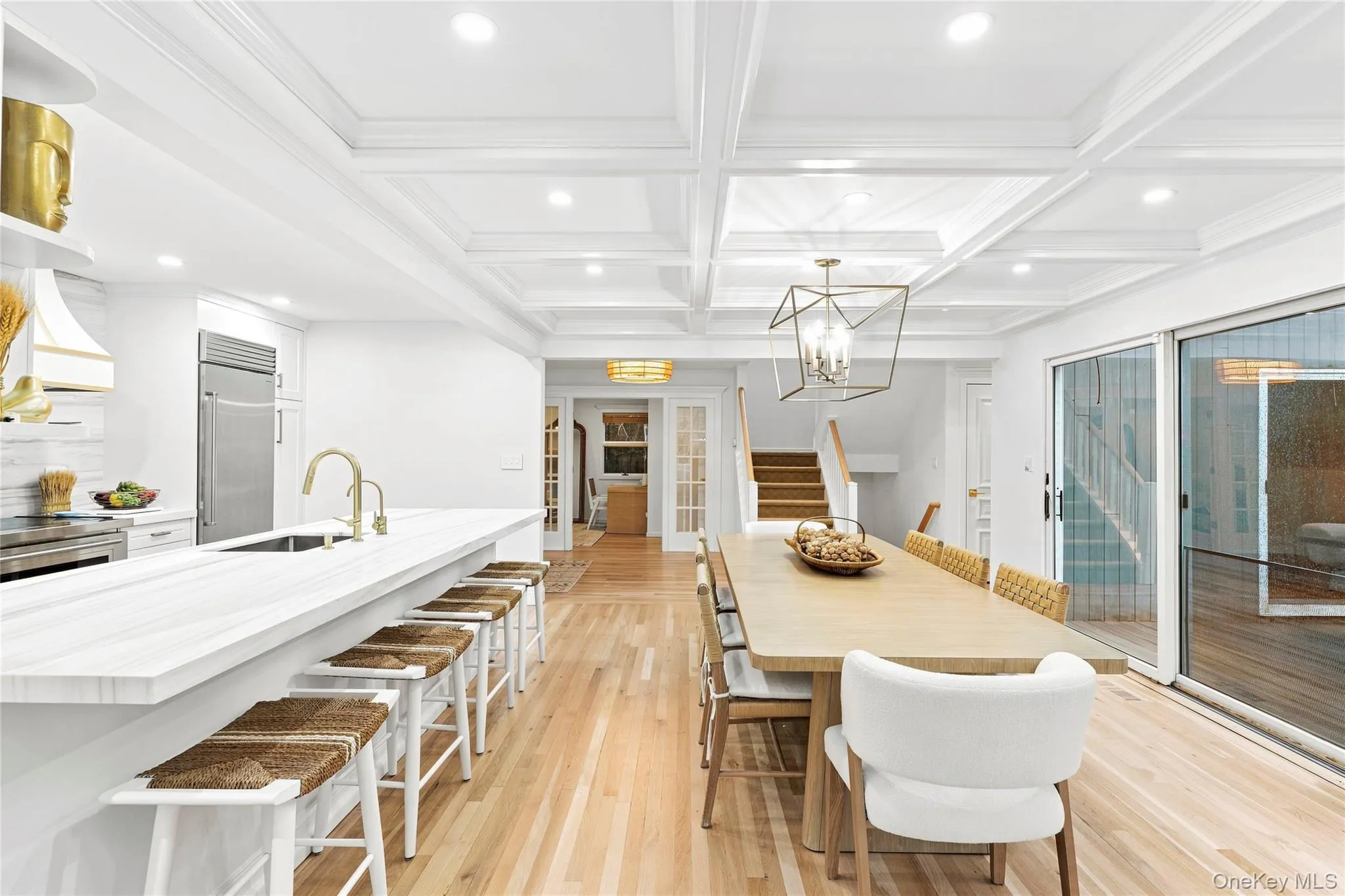 Dining area with marble breakfast bar and a view of the entry foyer in the background Dining area with marble breakfast bar and a view of the entry foyer in the background