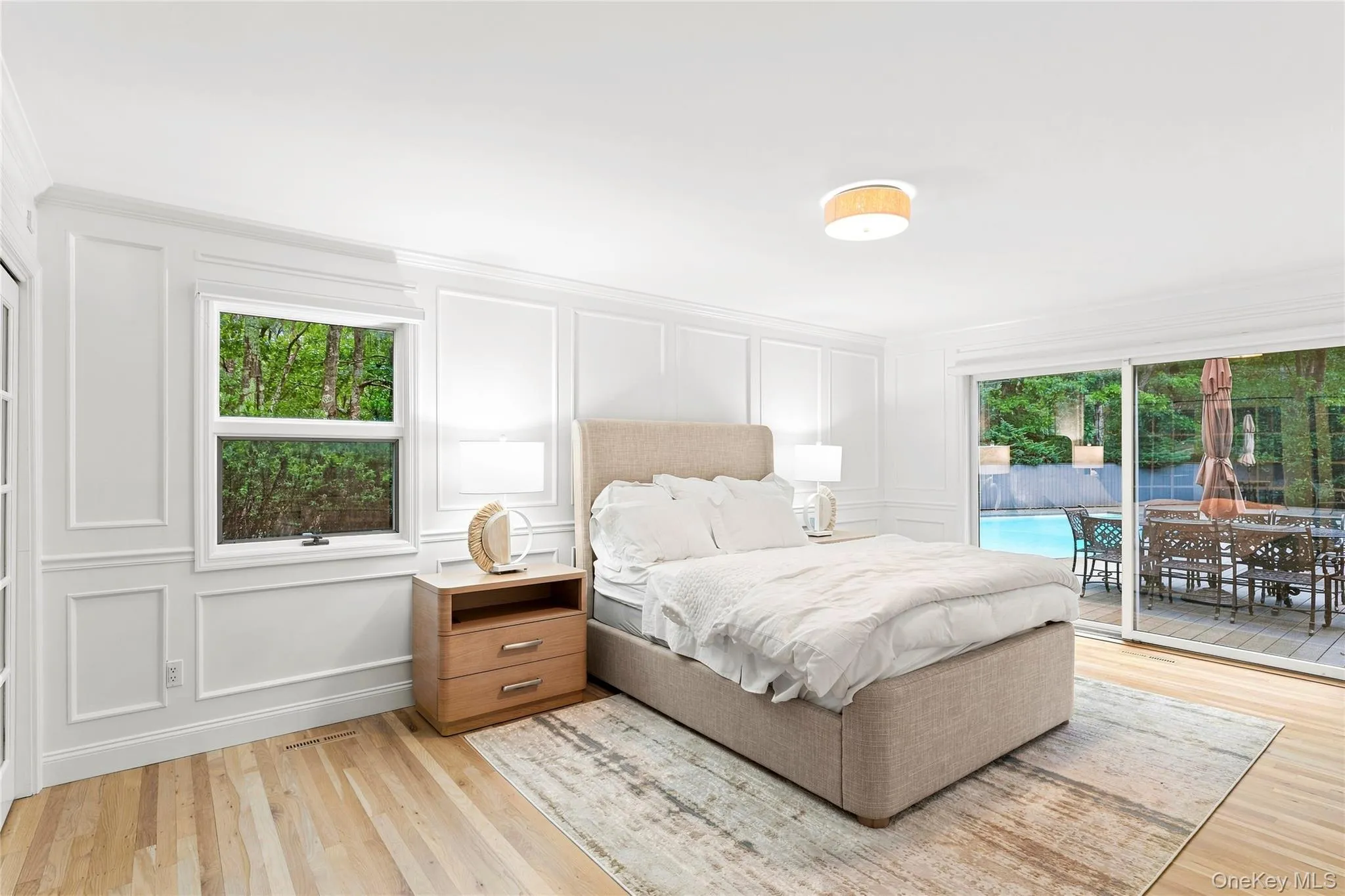 Spacious primary suite with deck and pool access and beautiful molding throughout Spacious primary suite with deck and pool access and beautiful molding throughout