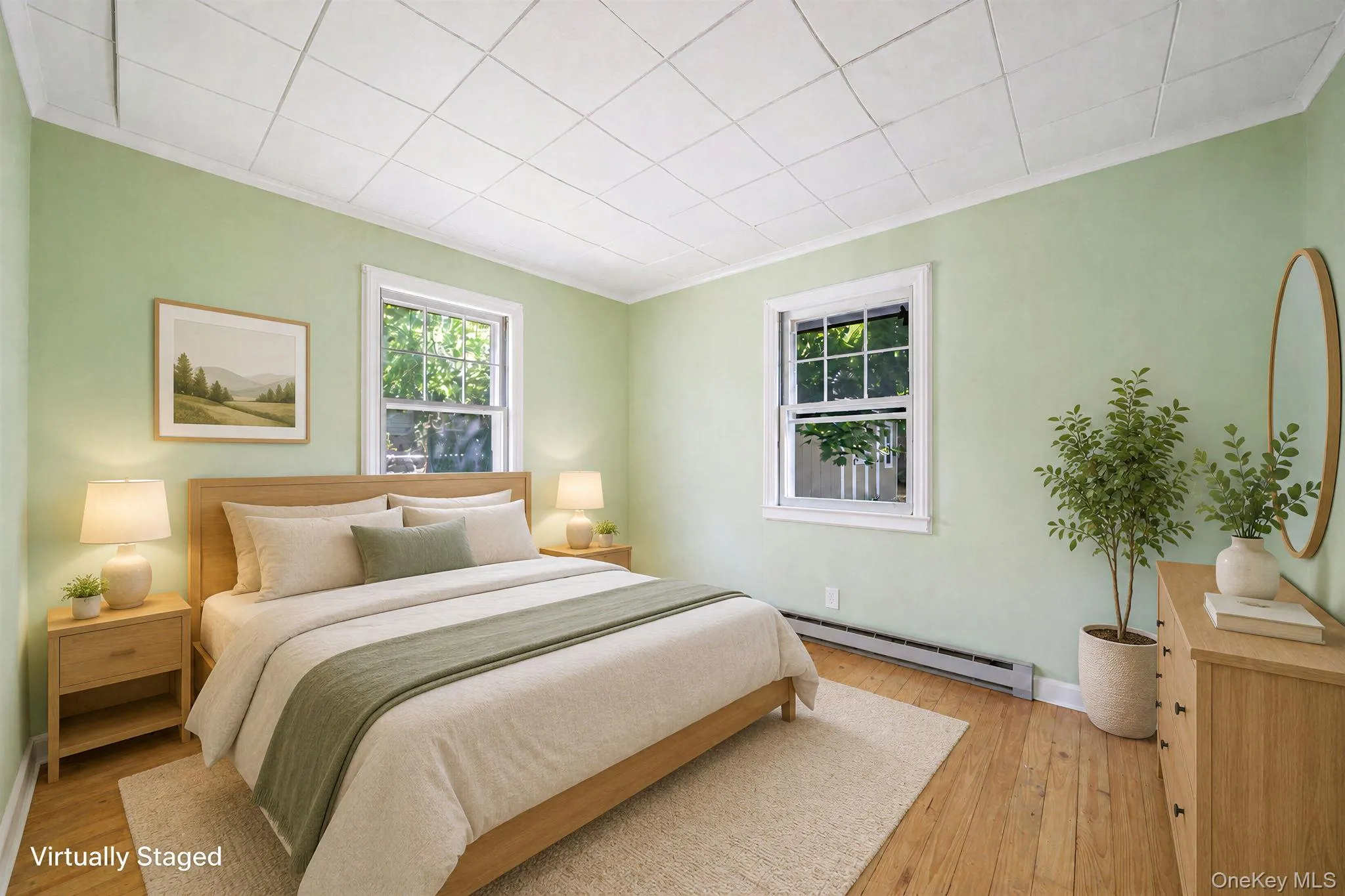 Hardwood flooring, two windows with white trim, baseboard heating, and a ceiling with square white panels Hardwood flooring, two windows with white trim, baseboard heating, and a ceiling with square white panels