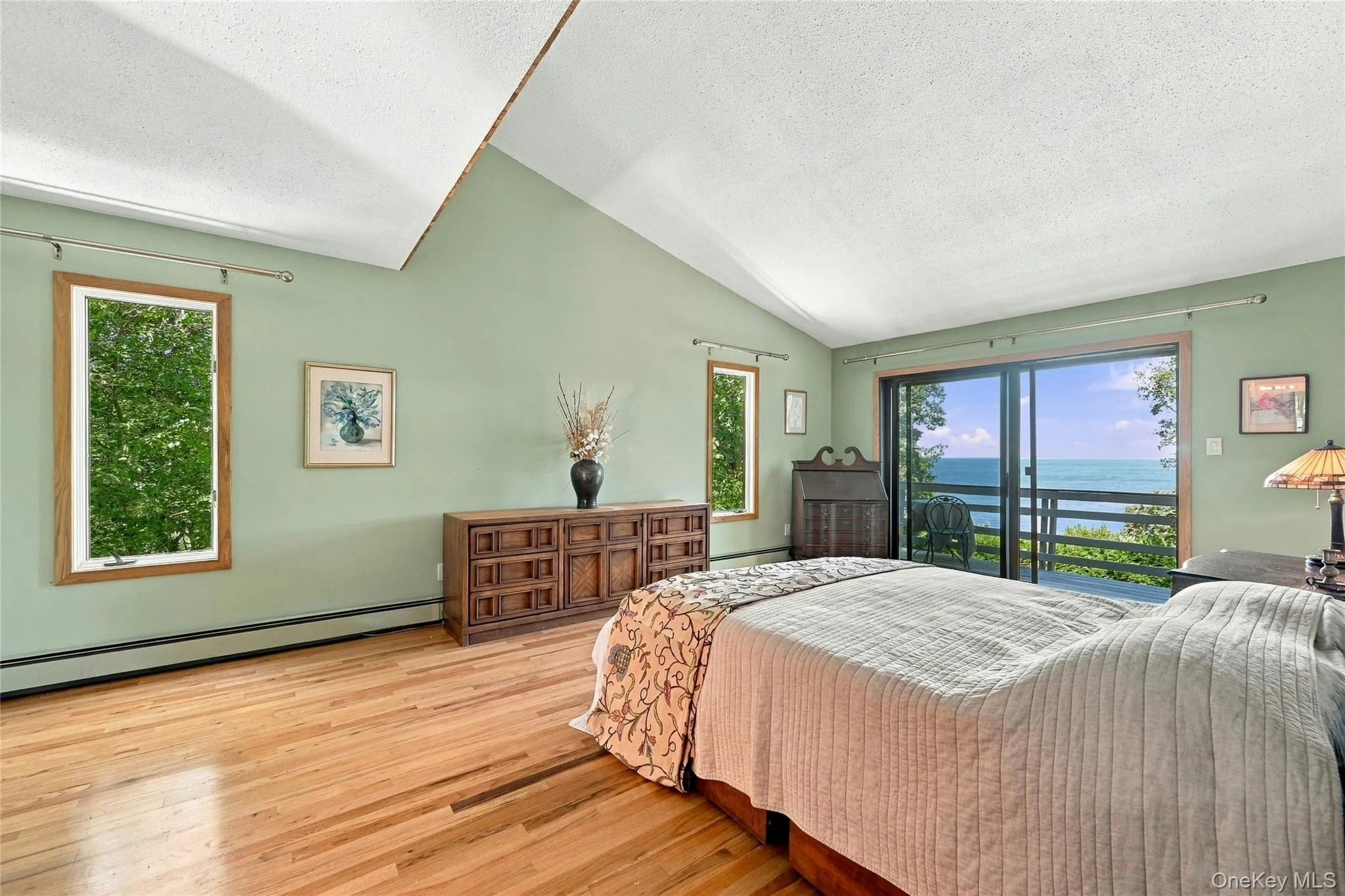 Primary Bed with Sliding Doors to Private Balcony and Water Views Primary Bed with Sliding Doors to Private Balcony and Water Views