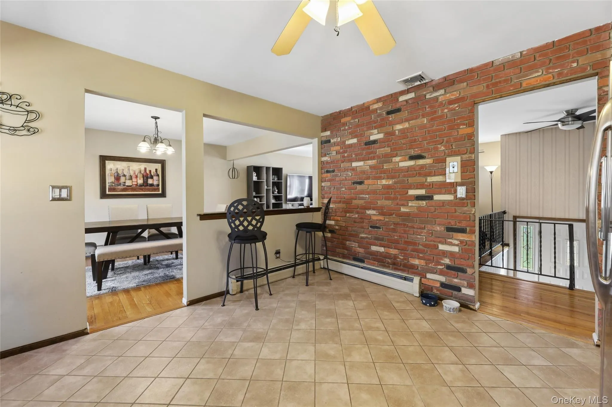 Open, sun-filled kitchen with open bar area Open, sun-filled kitchen with open bar area