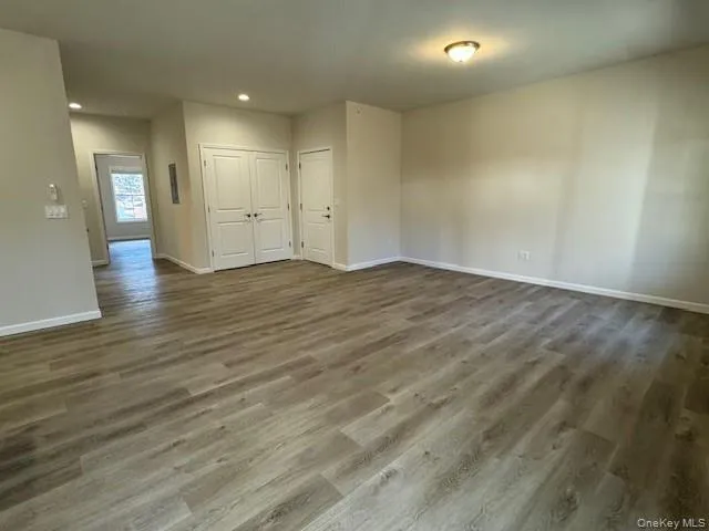 Spare room featuring dark hardwood / wood-style floors Spare room featuring dark hardwood / wood-style floors