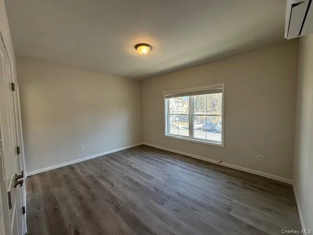 Empty room featuring dark wood-type flooring Empty room featuring dark wood-type flooring