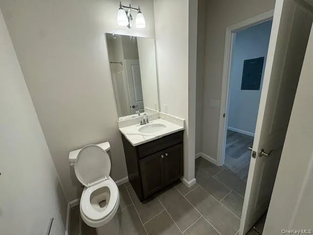 Bathroom with vanity, electric panel, and toilet Bathroom with vanity, electric panel, and toilet