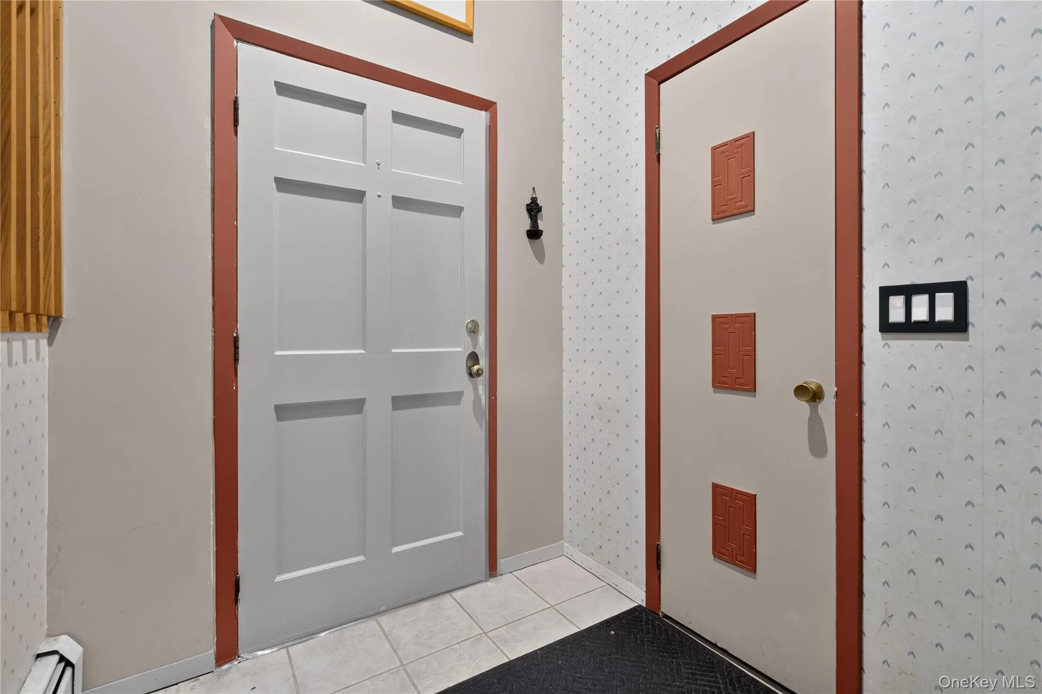 Landing by the front door with a full sized closet Landing by the front door with a full sized closet